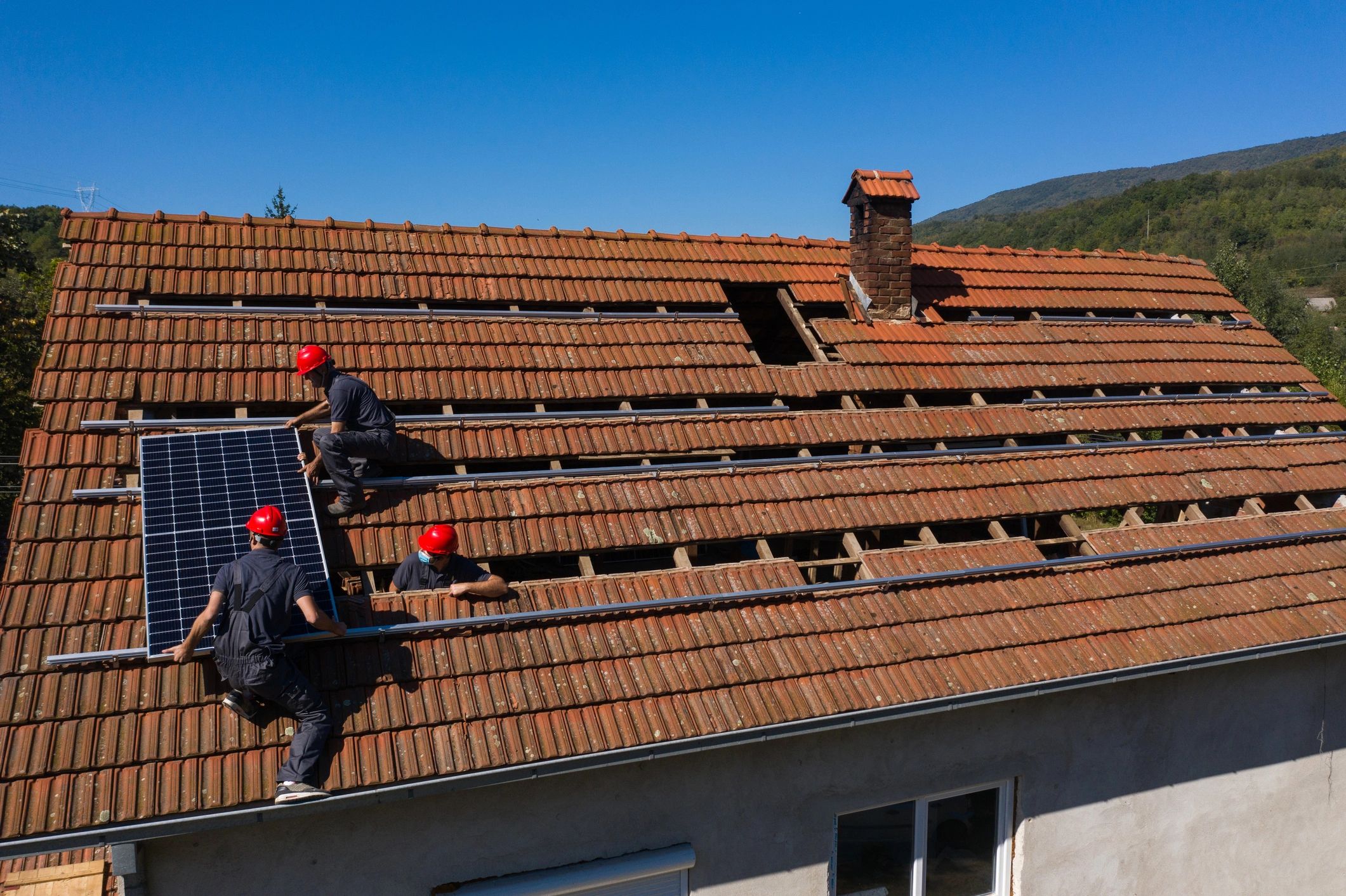 Roofing contractors working on a residential roof